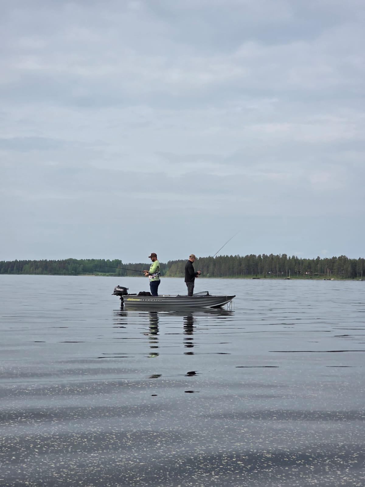 Two people fishing from a rented aluminium boat on Lake Siljan.
