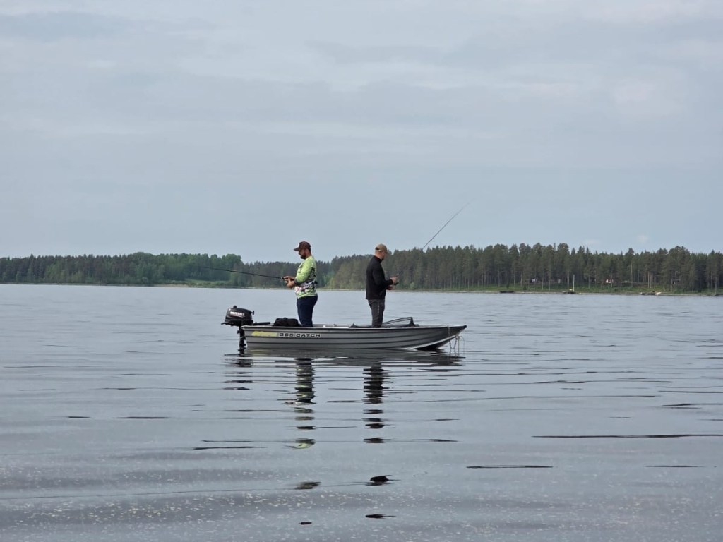 Two people fishing from a rented aluminium boat on Lake Siljan.